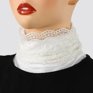 Close-up of a white lace neck scarf on a mannequin, highlighting its delicate floral texture