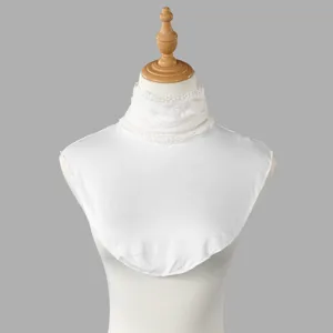 Close-up of a white knit dickey with a delicate lace-trimmed neckline on a display bust
