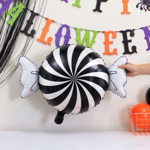 Spiral black-and-white foil candy balloon displayed beneath colorful Halloween party lettering