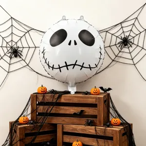 Halloween scene with a white skull foil balloon, spiderwebs, spiders and orange pumpkins