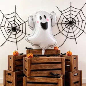 Halloween scene with a white ghost balloon, pink cheeks, black face, spiderwebs and pumpkins