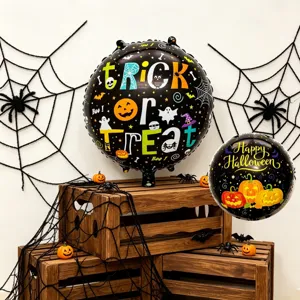 Two black foil balloons with colorful Halloween prints displayed among spiderwebs and wooden crates