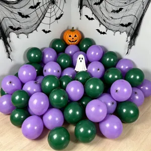 Dark green and purple round balloons arranged beneath Halloween spiderwebs, bats, pumpkin and ghost