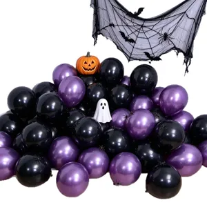 Close-up of black and purple balloons with a pumpkin, ghost, spiderweb and hanging bat accents