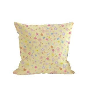 Square cushion cover with pale yellow base and colorful tiny floral print, shown on white background