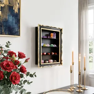 Wall-mounted black cabinet with ornate gold trim displays colorful crystals in a bright room