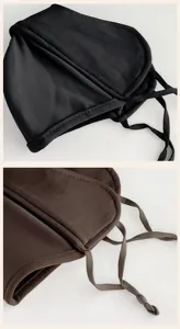 Close-up of black and brown fleece masks, showing stitched edges and adjustable tie straps