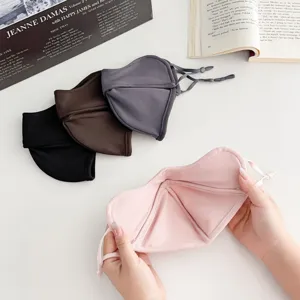 Four-color set of soft winter fabric face masks with adjustable ties, pink mask shown open