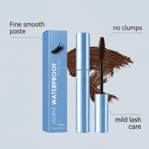 Close-up of a brown mascara swatch beside the blue tube, open wand and matching box