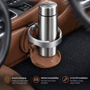 Close-up of a silver holding ring and brown base securing a stainless steel tumbler in a car