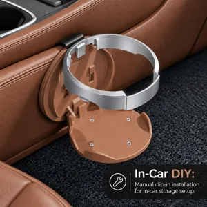 Close-up of a silver circular cup holder with a brown clip-in base mounted beside a car seat