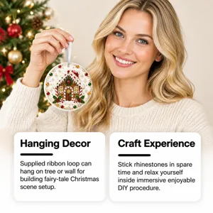 A woman holds a round gingerbread house ornament with rhinestones beside a lit Christmas tree.