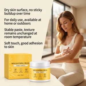 Woman applying soothing cream to her arm beside its yellow box and white jar in a warm room