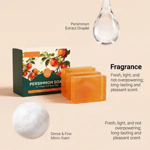 Still life of amber soap bars beside a green persimmon box, with a droplet and foam on peach