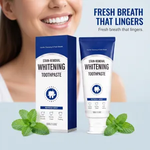 Blue-and-white tube and box beside fresh mint leaves, with a softly blurred smiling face behind