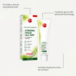 White and green box beside a squeeze tube, labeled 20 g, zinc-free and fresh mint denture gel