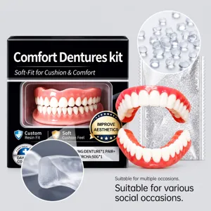 Close-up of pink gum-colored denture teeth beside soft-liner material beads and a black kit box