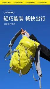 Yellow backpack with front zip pocket and gray mesh straps, held up against a clear blue sky