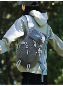 Rear view of a hiker wearing a gray outdoor backpack with zip pocket and straps in woods.