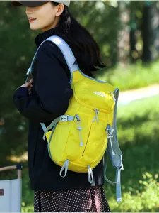 Side view of a woman wearing a bright yellow backpack with pale blue straps in a green forest.