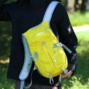 Lightweight outdoor hiking backpack in bright yellow with blue straps, shown worn outdoors