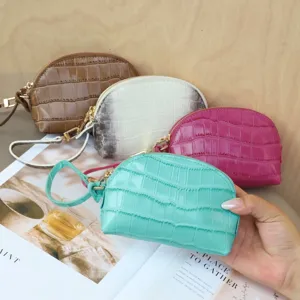 Four colorful half-moon zip pouches with embossed croc texture, gold hardware and wrist straps
