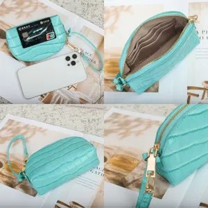 Four-view detail of mint crocodile-embossed wallet with gold zipper, card slots and wrist strap