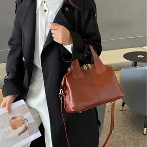 Brown leather Boston handbag with top handles, detachable strap and gold-tone hardware