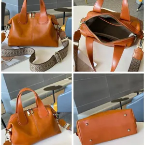 Orange-brown leather Boston bag with twin handles, zip closure and adjustable woven shoulder strap