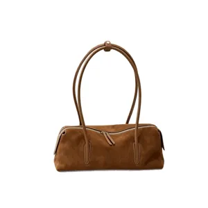 Brown suede women's bowling bag with a long barrel shape, twin handles and a zip-top closure