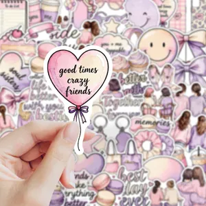 Close-up of a hand holding a pink heart balloon sticker among pastel illustrated designs
