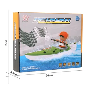 Green and white RC kayak toy boat with an orange-helmeted rider, shown in front of its box