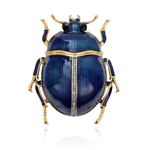 Front view of a blue enamel beetle with antique gold-tone details and clear rhinestone accents