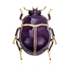 Purple enamel beetle brooch with antique gold-tone legs and small pink and black rhinestone accents