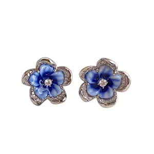 Pair of S925 silver flower stud earrings with blue and white enamel petals, sparkling center stones