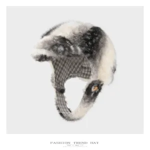 Close-up of a gray and ivory faux-fur earflap hat with plaid lining and a wooden button