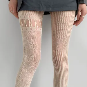 Close-up of cream tights with oval cutouts, diamond mesh and vertical stripe patterns