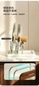 Close-up of sturdy metal dividers holding glass pot lids upright on a white countertop rack