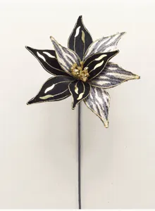 Vue détaillée d’une fleur artificielle noire et dorée, aux pétales scintillants et à la tige fine