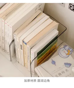 Close-up of a clear acrylic book divider with rounded edges holding a row of books on a desk