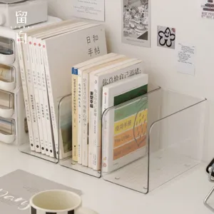 Clear acrylic desktop book organizer holding upright books in a neat home or office workspace