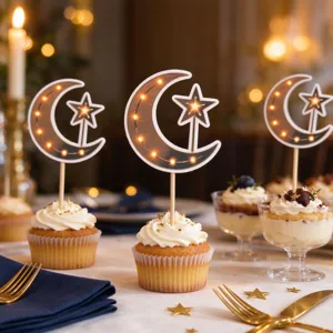 Warm LED-lit crescent moon and star toppers decorate cupcakes on a festive dessert table