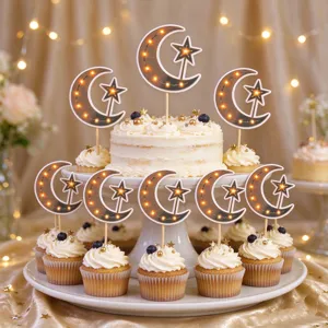 Cake and cupcakes topped with crescent moon and star picks against a softly lit golden backdrop