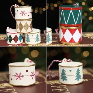 Close-up of hand-painted miniature drums with festive patterns and red-white hanging cords