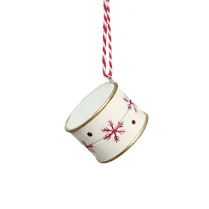 White metal drum Christmas ornament with gold trim, red snowflakes and a red-and-white hanging cord