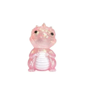 Front view of a translucent pink dragon figurine with glitter accents and a pearly white belly