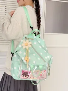 Sac à dos vert menthe à pois blancs, avec poche transparente et pendentif fleur, vu de dos