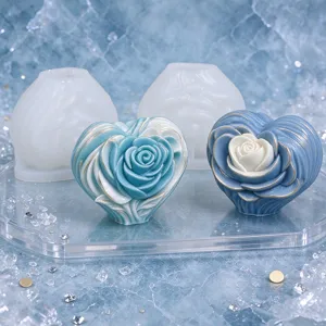 Blue and blue-white rose heart casts displayed beside white silicone molds on a clear tray