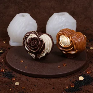 Close-up display of white rose-heart silicone molds beside brown and cream molded pieces