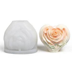 White silicone rose mold beside a finished heart-shaped candle in soft peach and ivory tones